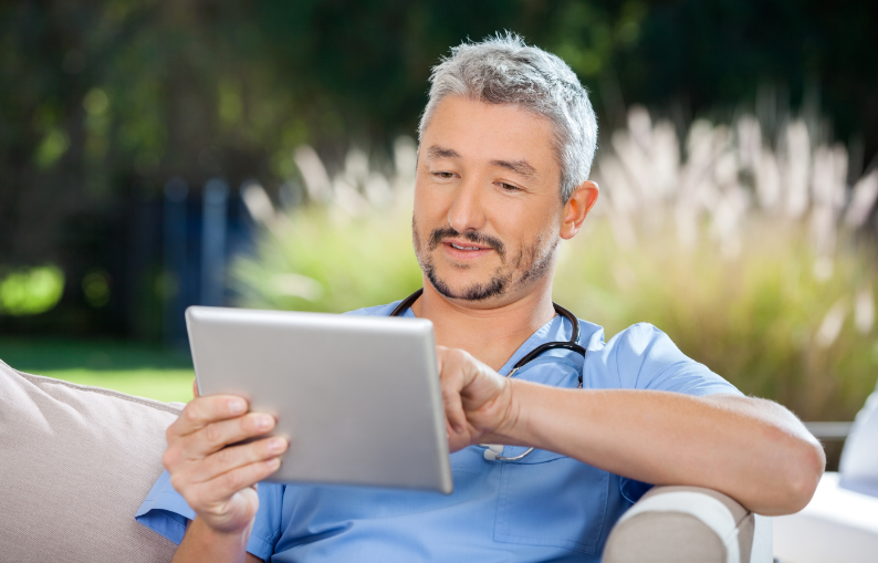 Male Doctor Reading eBook 