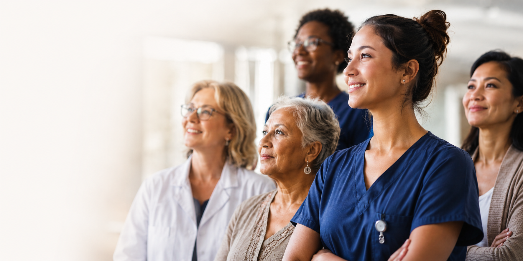 Diverse group of women in health-care and professional roles standing together in a bright, welcoming setting.